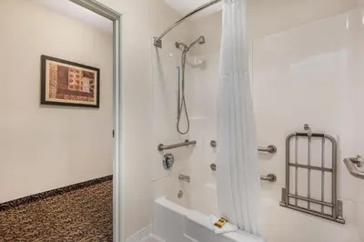 a bathroom with a shower with a shower curtain at Best Western Plus Boulder Louisville in Louisville