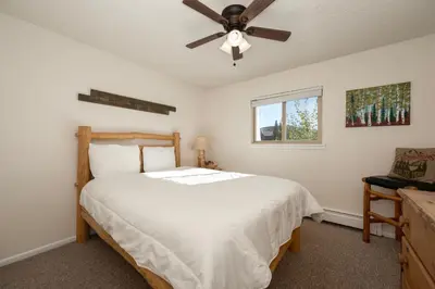 a bedroom with a bed and a ceiling fan at Hi Country Haus Unit 1515 in Winter Park