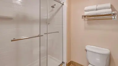a bathroom with a shower and a toilet at Best Western Plus Gateway Inn & Suites - Aurora in Aurora