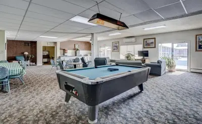 a room with a pool table in a room at Americas Best Value Inn Greeley in Evans
