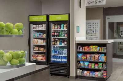 a store with two refrigerators with food and drinks at Home2 Suites By Hilton Longmont in Longmont