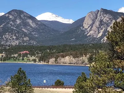 a view of a lake with mountains in the background at Estes Lake Lodge in Estes Park