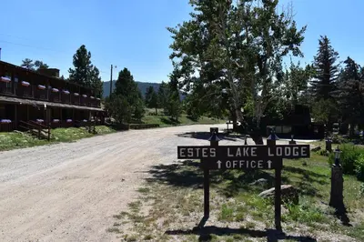 a sign that says elite lake lodge on a dirt road at Estes Lake Lodge in Estes Park