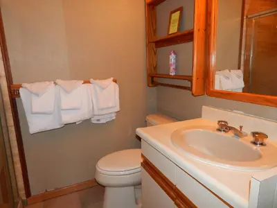 a bathroom with a sink and a toilet and a mirror at 61 Jabberwocky Home by Stay Winter Park in Fraser
