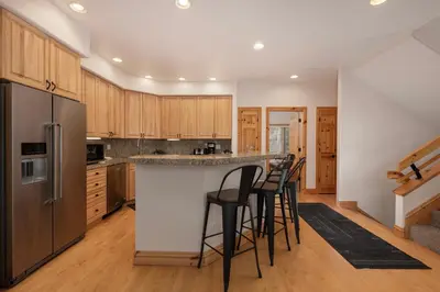 a kitchen with a bar with stools in it at Timber Lake 341 in Winter Park