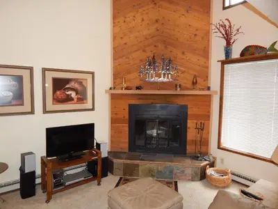 a living room with a fireplace and a tv at Timber Ridge Building B, Unit 2 in Winter Park