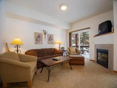 a living room with a couch and a fireplace at Winterstar Building G #3 by Stay Winter Park in Fraser