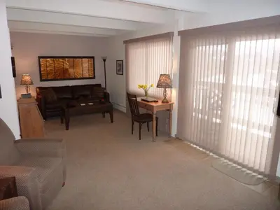 a living room with a couch and a table at Heart of Frisco Condo in Frisco