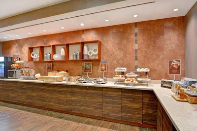 a bakery with a counter with food on it at SpringHill Suites Denver at Anschutz Medical Campus in Aurora