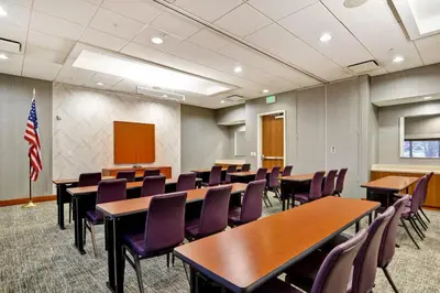 a conference room with tables and chairs and an american flag at SpringHill Suites Denver at Anschutz Medical Campus in Aurora