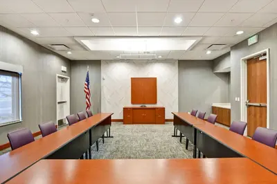 a conference room with desks and chairs and a podium at SpringHill Suites Denver at Anschutz Medical Campus in Aurora