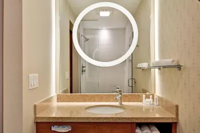 a bathroom with a sink and a mirror at SpringHill Suites Denver at Anschutz Medical Campus in Aurora