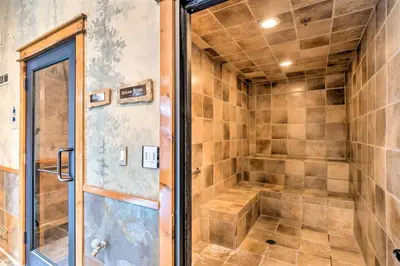 a walk in shower with a glass door at The Timbers Ski-In, Ski-Out 1 Bedroom Plus Murphy in Keystone