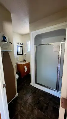 a bathroom with a shower and a toilet and a sink at Murphy's River Lodge in Estes Park