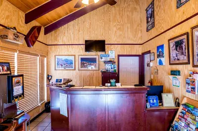 a bar in a restaurant with wooden walls at Murphy's River Lodge in Estes Park