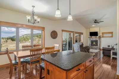 a kitchen and living room with a table and a dining room at Coyote Ridge Condo in Estes Park