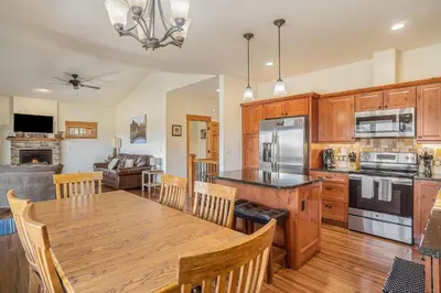 a kitchen and dining room with a wooden table at Coyote Ridge Condo in Estes Park