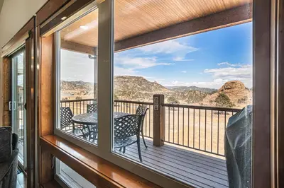 a view from a balcony with a table and chairs at Coyote Ridge Condo in Estes Park