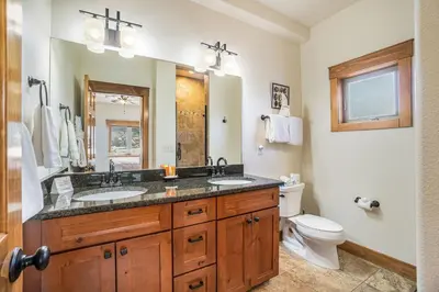 a bathroom with two sinks and a toilet at Coyote Ridge Condo in Estes Park