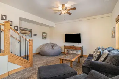 a living room with a couch and a flat screen tv at Coyote Ridge Condo in Estes Park