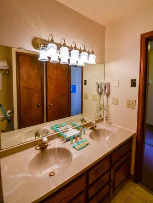 a bathroom with two sinks and a large mirror at The Inn at Silvercreek in Granby