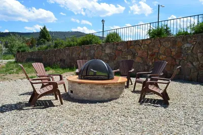 a group of chairs sitting around a fire pit at The Inn at Silvercreek in Granby