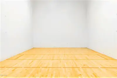 an empty room with a wooden floor and white walls at The Inn at Silvercreek in Granby