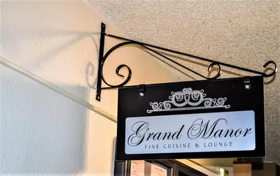 a sign for a grand woman fine dining and lounge at The Inn at Silvercreek in Granby