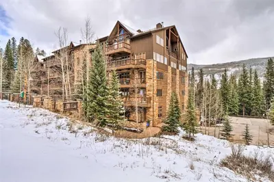 a large wooden house in the woods in the snow at Ski-In, Ski-Out 1 Bedroom Plus Murphy At The Timbers in Keystone
