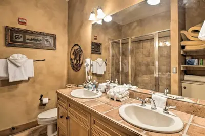 a bathroom with two sinks and a toilet at Ski-In, Ski-Out 1 Bedroom Plus Murphy At The Timbers in Keystone