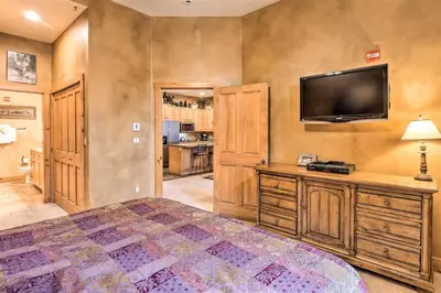 a bedroom with a large bed and a flat screen tv at Ski-In, Ski-Out 1 Bedroom Plus Murphy At The Timbers in Keystone
