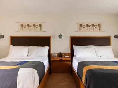 two beds sitting next to each other in a room at Trailhead Lodge in Estes Park
