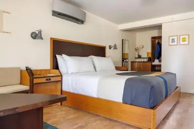 a bedroom with a bed and a desk and a couch at Trailhead Lodge in Estes Park