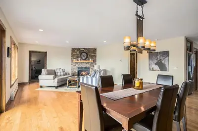 a dining room and living room with a table and chairs at Snowline Vista Lodge in Estes Park