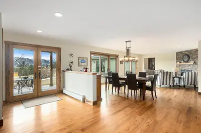 a dining room and living room with a table and chairs at Snowline Vista Lodge in Estes Park