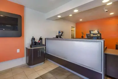 a waiting room with a large screen in a restaurant at Park Inn by Radisson, Lakewood in Lakewood