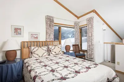 a bedroom with a bed with a quilt on it at Ski Run - Mountain House Keystone in Keystone