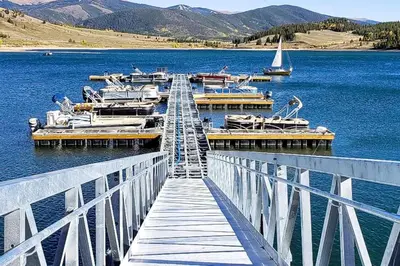 a dock with boats docked on a lake at Snowdance - Keystone in Dillon