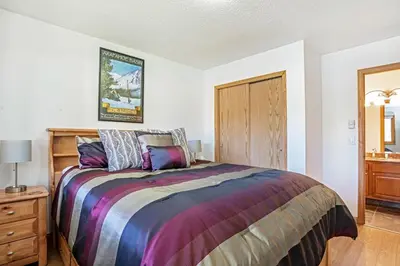 a bedroom with a bed and a wooden dresser at Snowdance - Keystone in Dillon