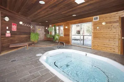 a jacuzzi tub in a room with wooden walls at Snowdance - Keystone in Dillon