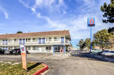 a building with a sign in front of a parking lot at Motel 6 Fort Collins, CO in Fort Collins