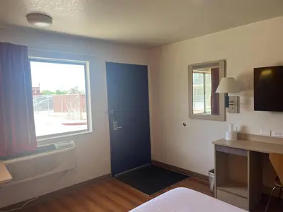 a room with a blue door and a window at Motel 6 Fort Collins, CO in Fort Collins
