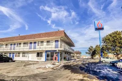 a building with a sign in a parking lot at Motel 6 Fort Collins, CO in Fort Collins