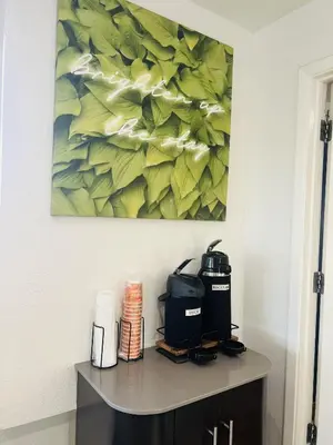 a painting hanging above a table in a room at Motel 6 Fort Collins, CO in Fort Collins