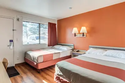 a hotel room with two beds and a window at Motel 6 Fort Collins, CO in Fort Collins