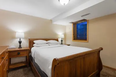 a bedroom with a large bed and a window at Discovery Lodge in Estes Park