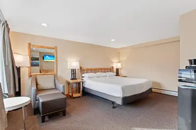 a hotel room with a bed and a chair at Discovery Lodge in Estes Park