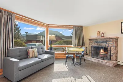 a living room with a couch and a fireplace at Discovery Lodge in Estes Park