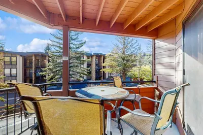 a patio with a table and chairs on a balcony at La Bonte Leisure Beauty in Dillon