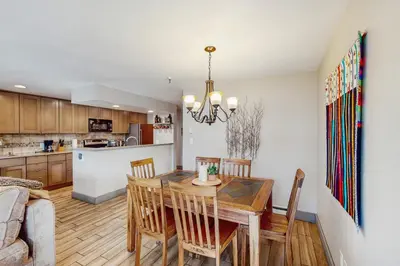 a kitchen and dining room with a wooden table and chairs at La Bonte Leisure Beauty in Dillon